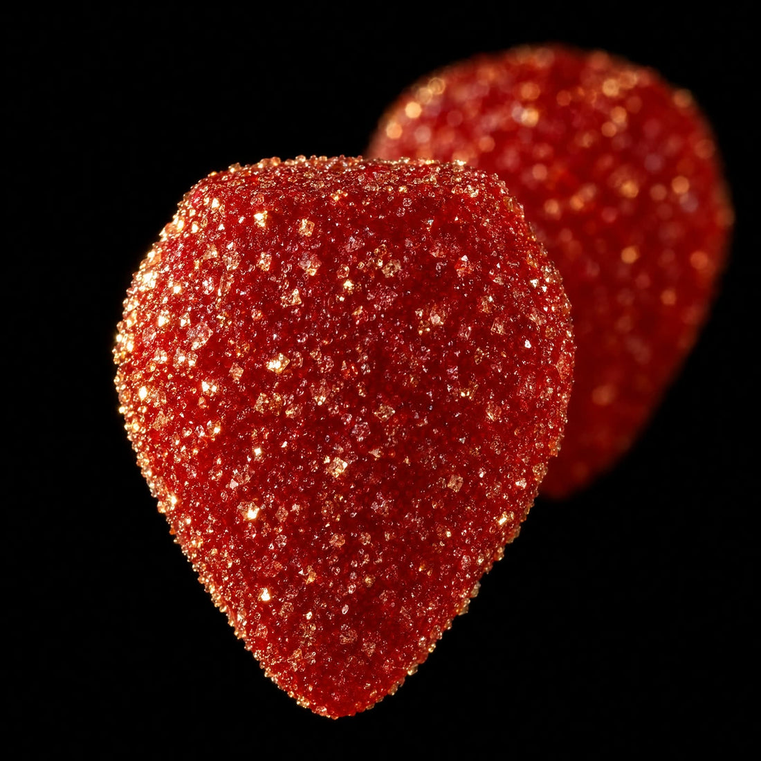 AI-generated illustration: close-up of a single sugar-dusted red gummy on a black background